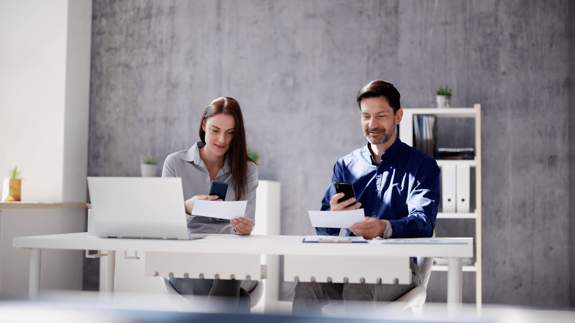Businesspeople depositing checks with their smartphones